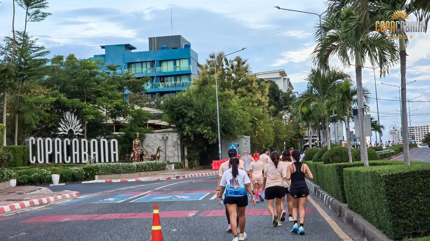 Runners passing the Copacabana sign